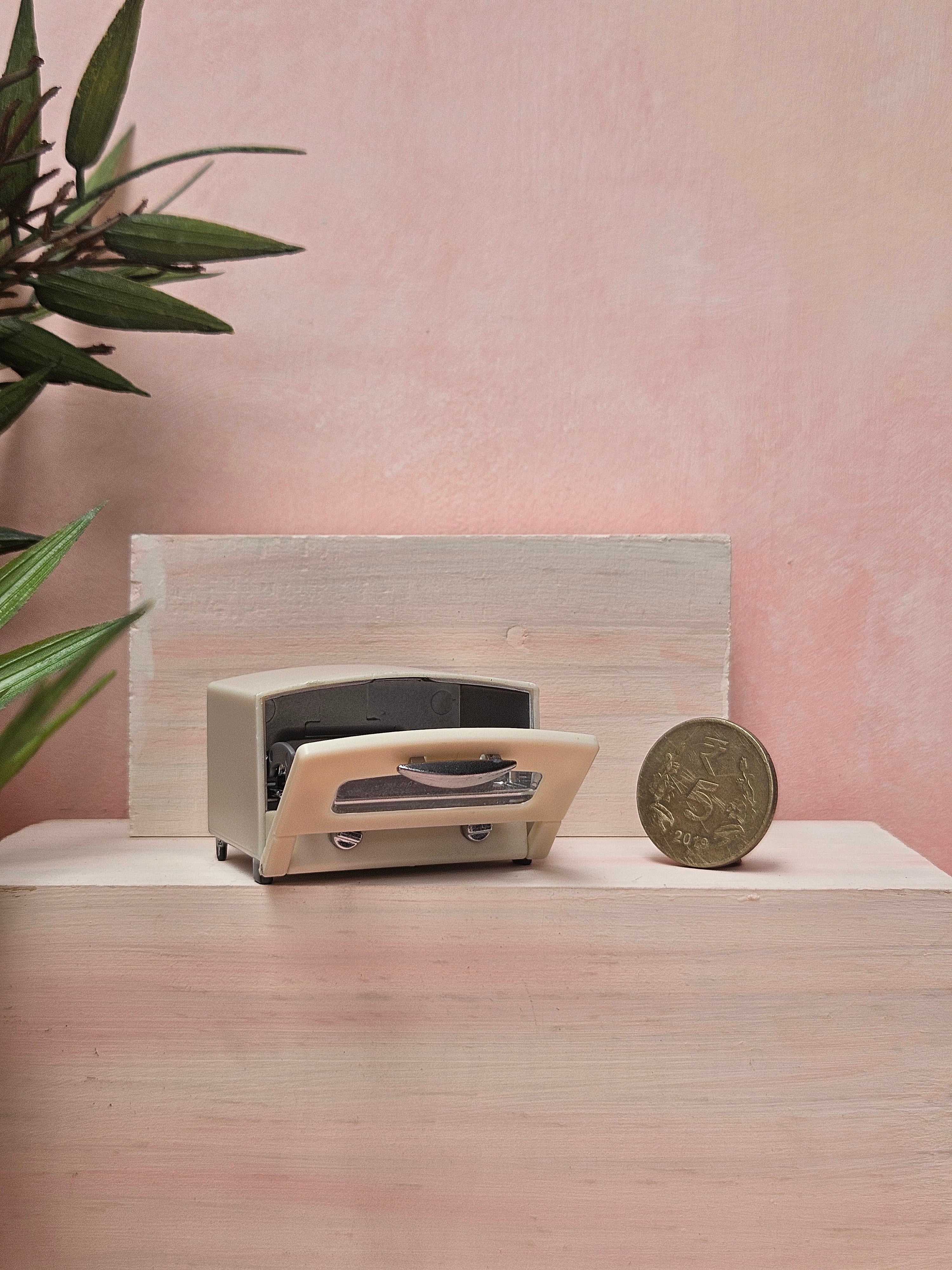 "Miniature oven collectible for dollhouse cooking scene"