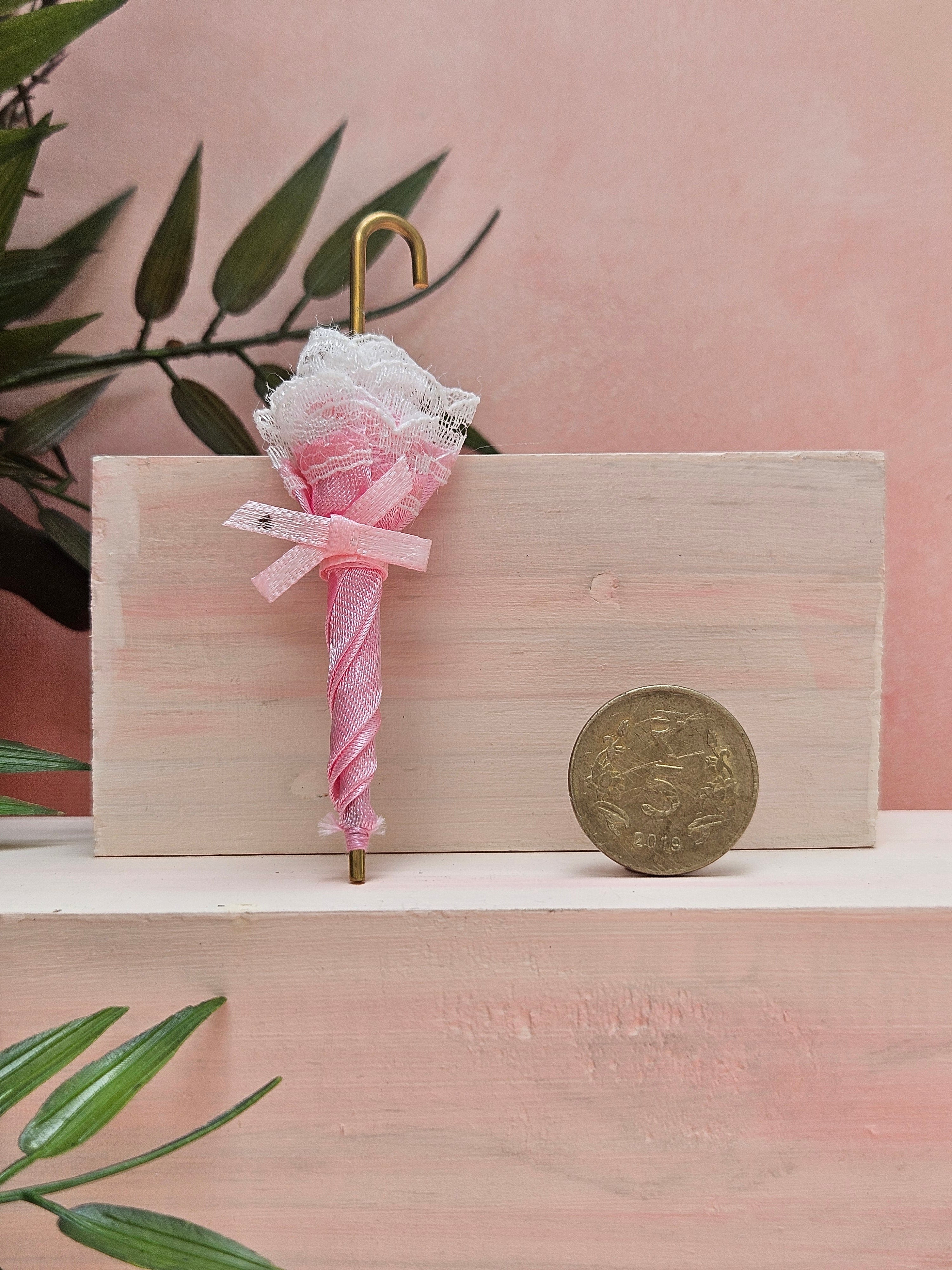 Miniature umbrella collectible with realistic detailing for dollhouse décor and displays.