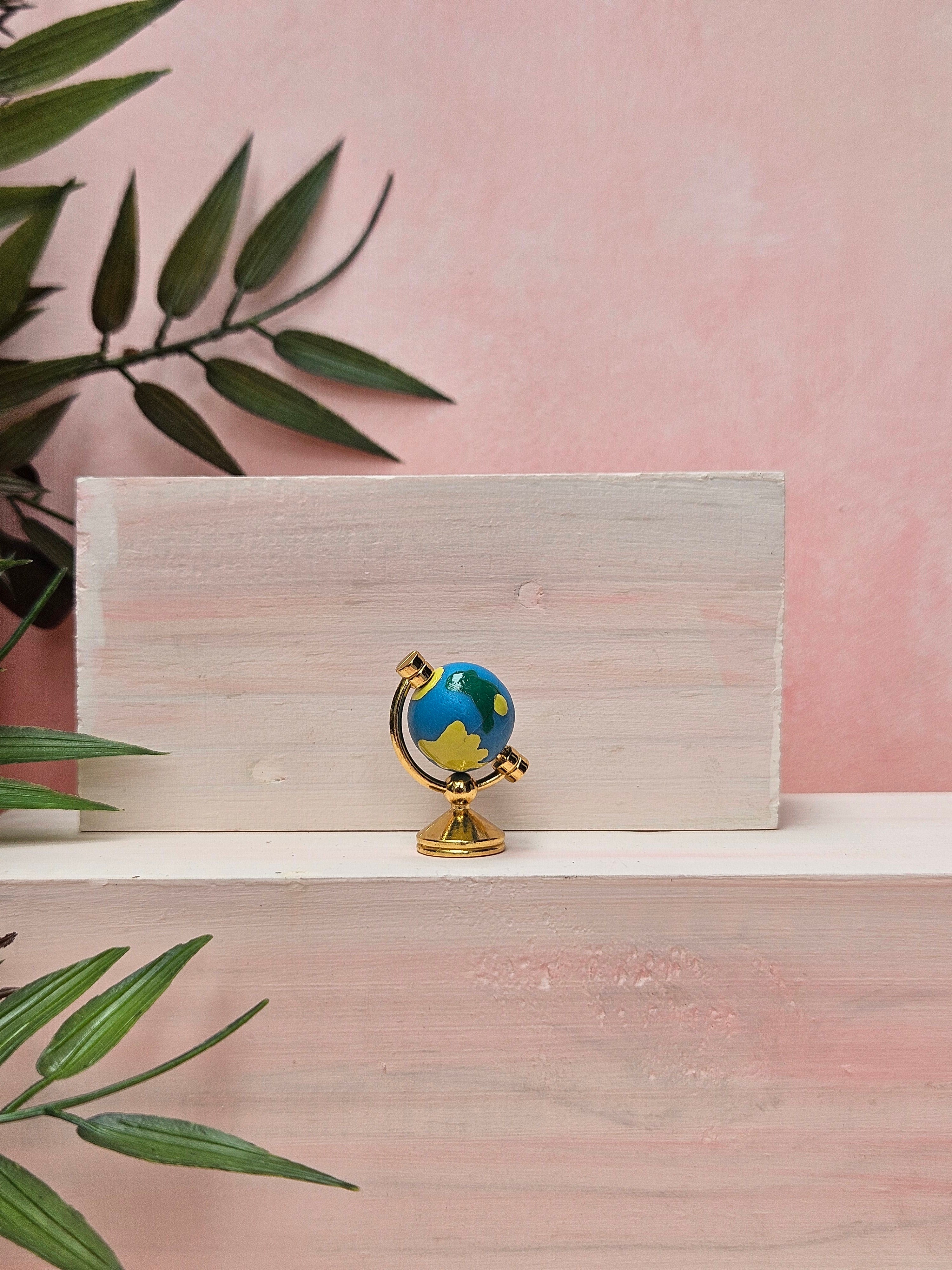 Miniature globe with detailed world map design for desk décor and collectible displays in India