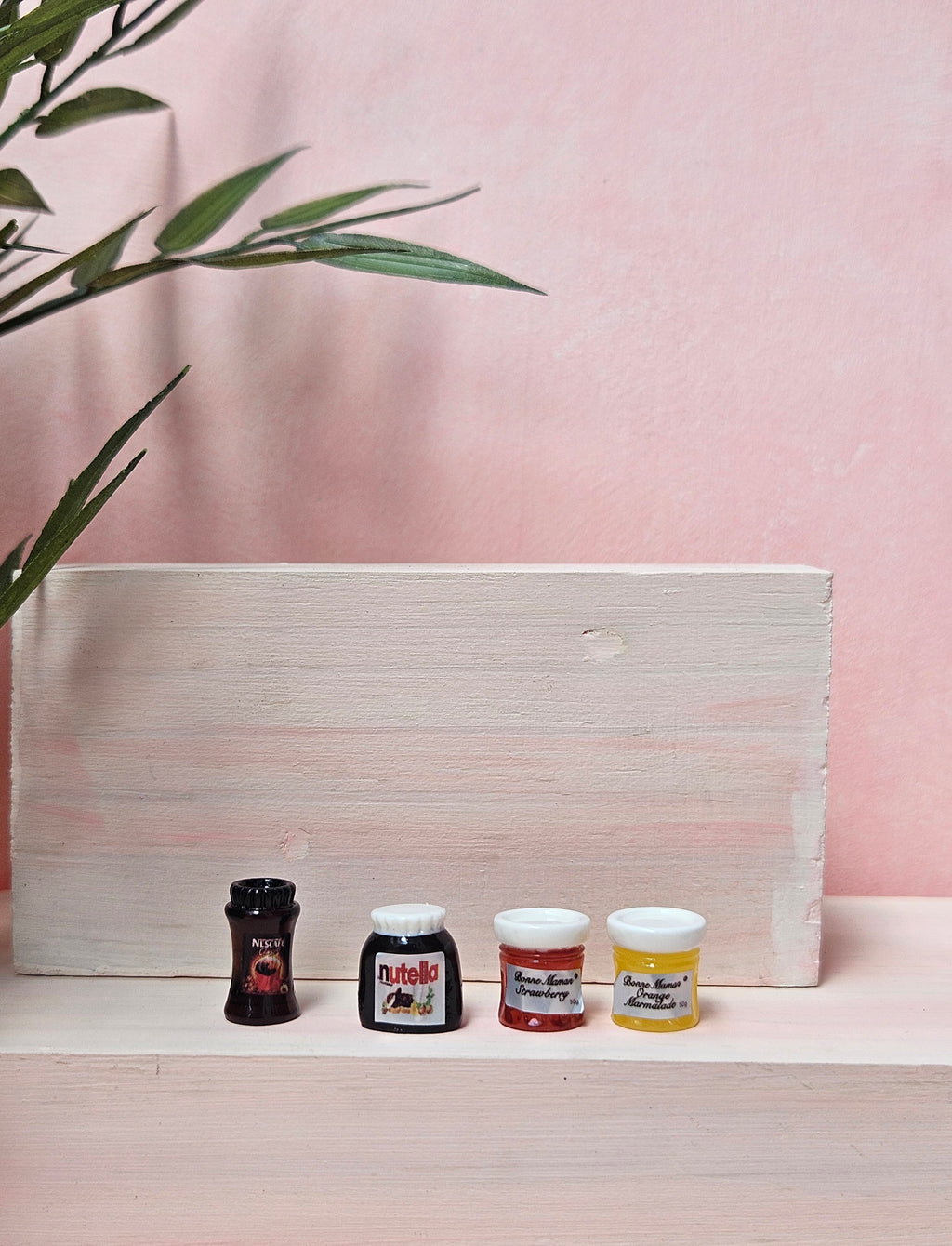Miniature assorted jars of coffee, Nutella, and jam for dollhouse and crafts in India.