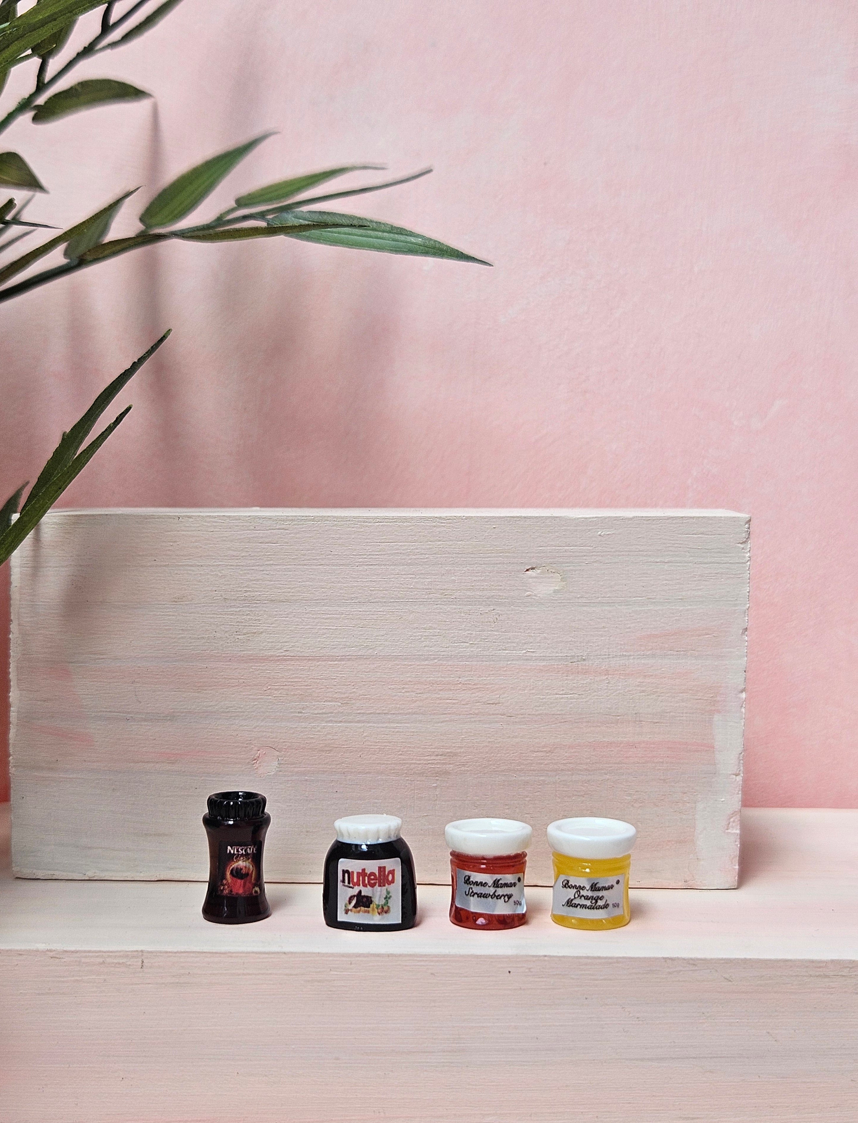 Miniature assorted jars of coffee, Nutella, and jam for dollhouse and crafts in India.