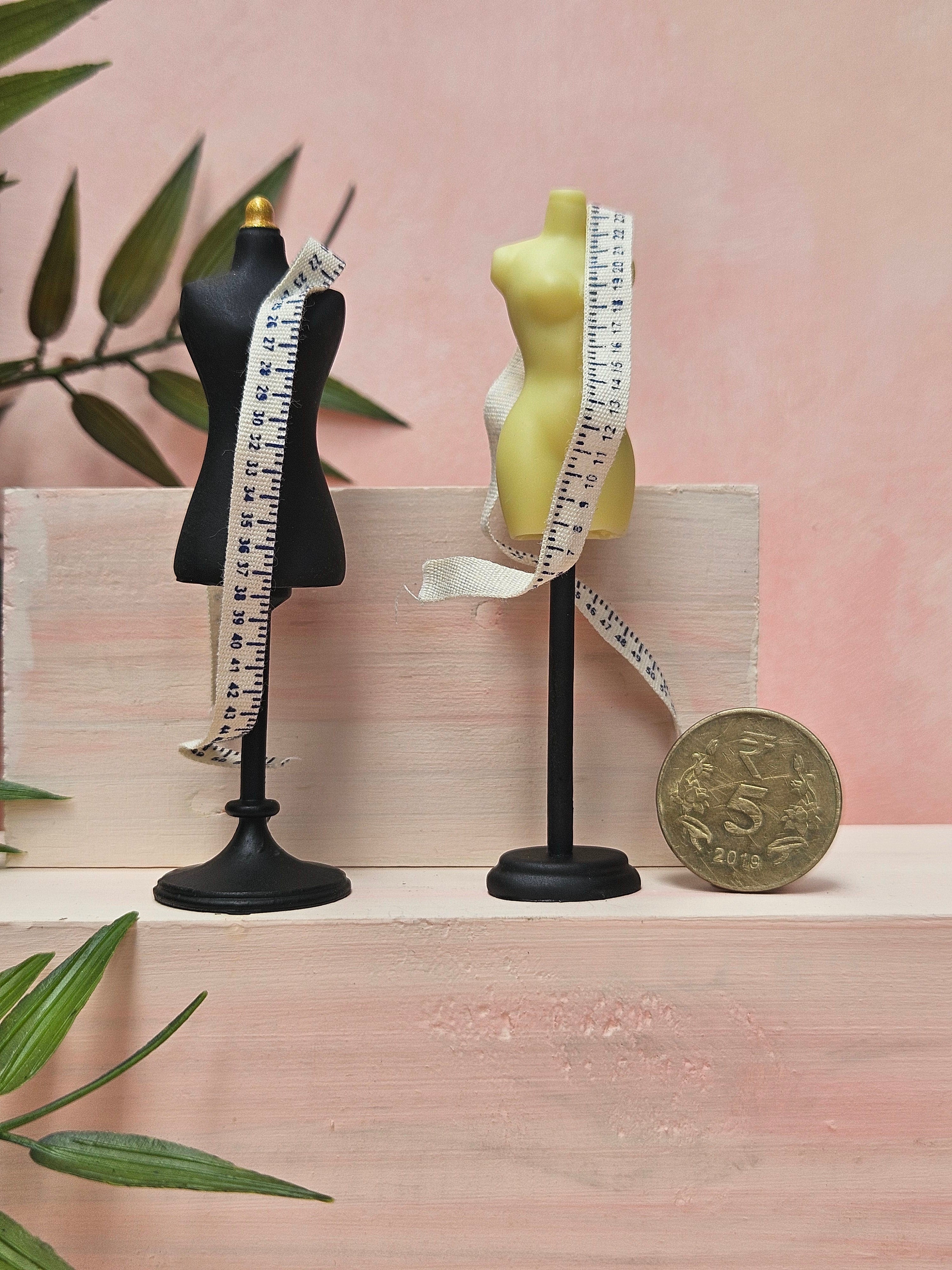 Miniature mannequin with tape collectible sewing accessory for dollhouse displays.