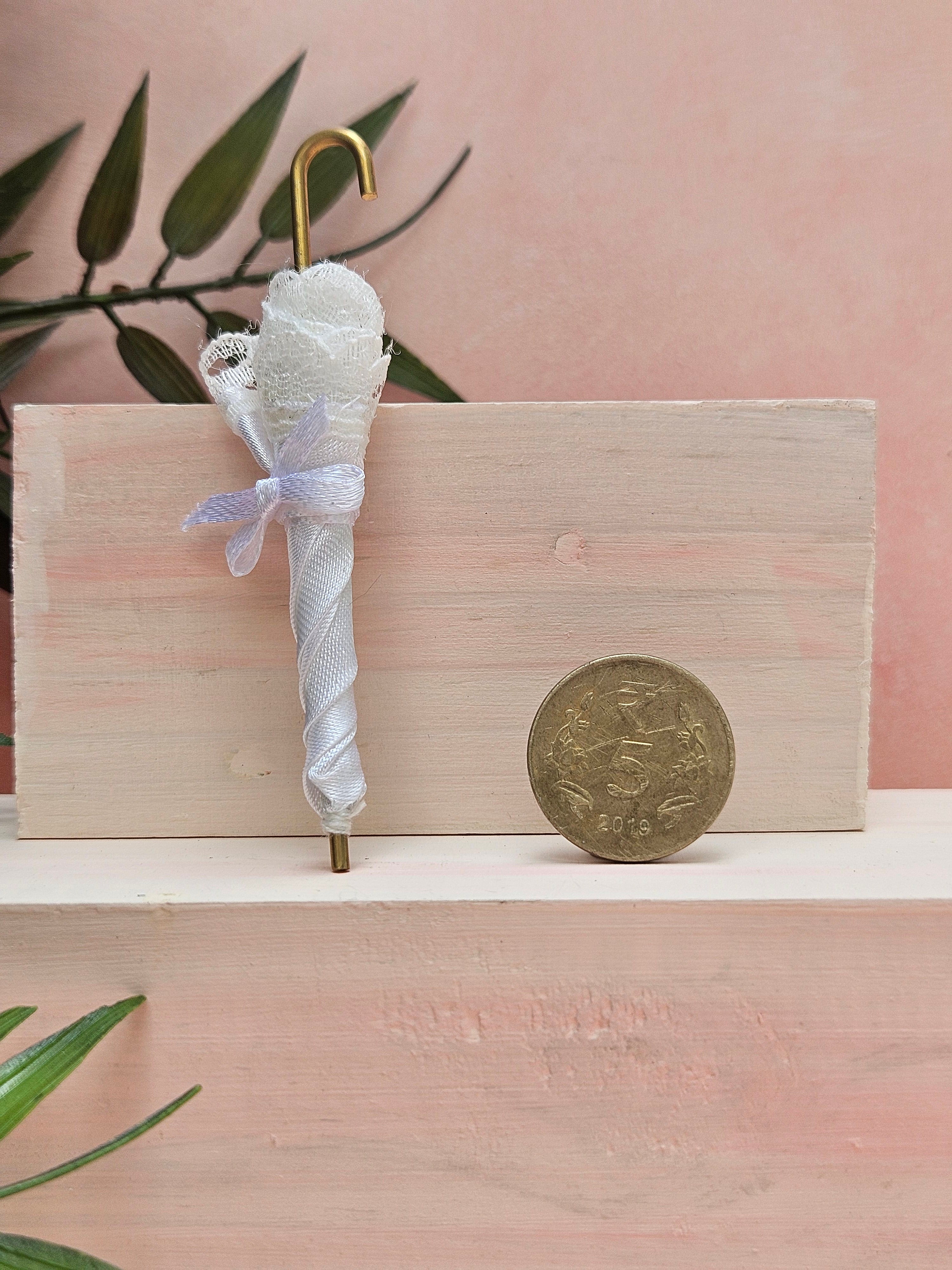 Miniature umbrella dollhouse accessory and collectible gift with cute design.